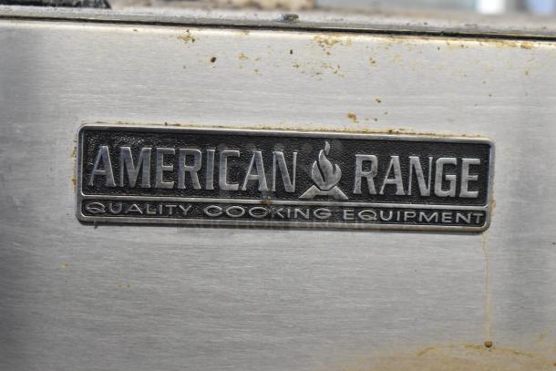 American Range commercial gas-powered rotisserie oven, stainless steel exterior with visible brand logo, showing signs of use.