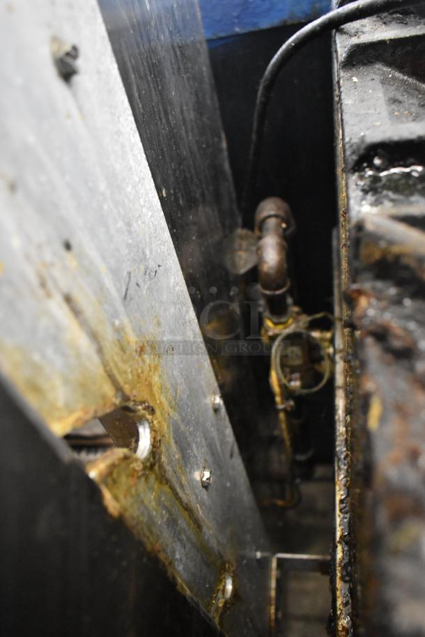 American Range Commercial Gas Rotisserie Oven, showing interior mechanics. Metal components, visible wear and residue.