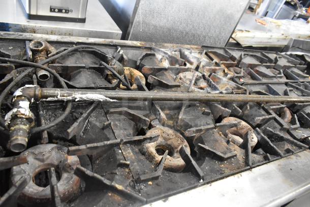 Radiance Commercial 6 Burner Gas Range in used condition, mounted on Everest 4 Drawer Chef Base, multiple visible gas lines.