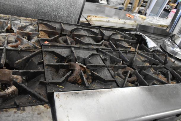 Radiance 6 burner gas range with visible wear and surface rust on grates, placed on Everest 4 drawer chef base.