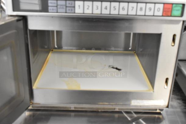Panasonic NE-21521 Commercial Countertop Microwave Oven, 208 Volts, 1 Phase, interior shows stains, keypad visible.
