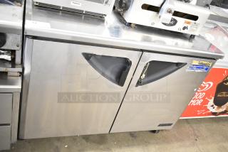 Turbo Air TWR-48SD undercounter cooler, 2-door, commercial casters, 115V, stainless steel, visible wear, model tag shown.