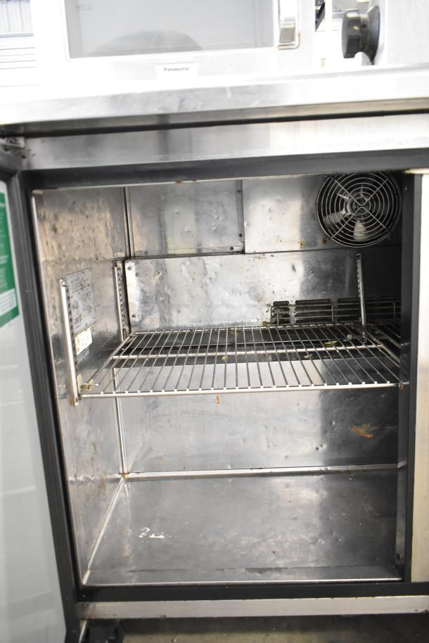 Turbo Air TWR-48SD two-door undercounter cooler, commercial casters, stainless steel interior, visible wear, 115V, 1 phase.