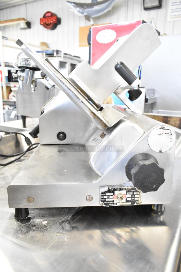 Globe commercial meat slicer with blade sharpener, 115 volts, 1 phase. Features adjustment knobs and visible brand label.