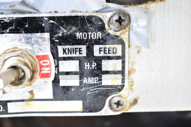"Motor label on Globe commercial meat slicer, showing settings for knife and feed, with HP and AMP blanks. Rust visible."