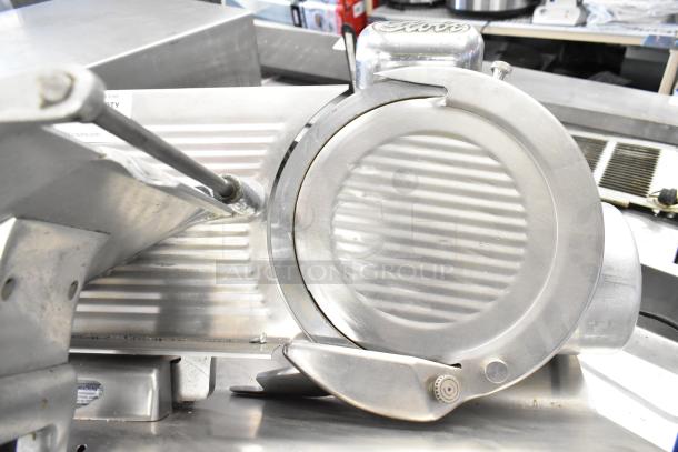 Globe commercial countertop meat slicer with blade sharpener, 115 volts, 1 phase, used, stainless steel exterior.