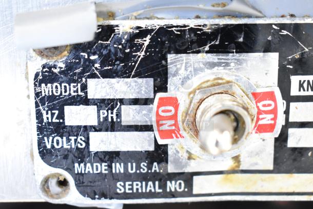 Globe Commercial Countertop Meat Slicer with blade sharpener. Scratched label shows 115 volts, 1 phase, made in USA.