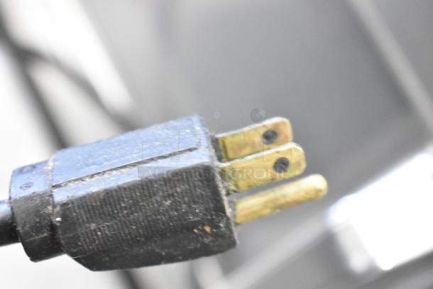 Globe commercial meat slicer power plug, 115 volts, 1 phase; close-up view showing condition and blade sharpener inclusion.