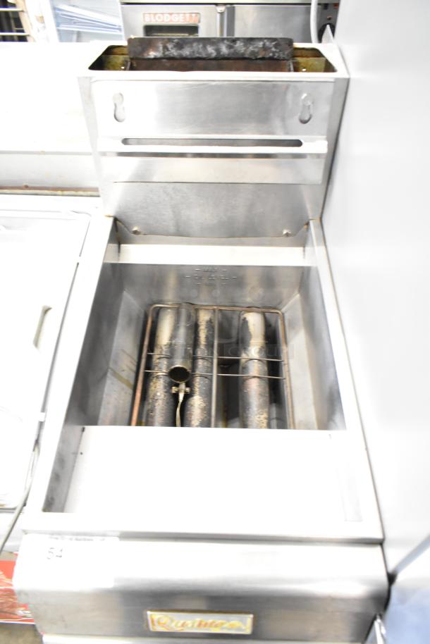 Qualite Commercial Floor Style Gas Powered Deep Fat Fryer, stainless steel, used, visible burner tubes, Qualite label on front.