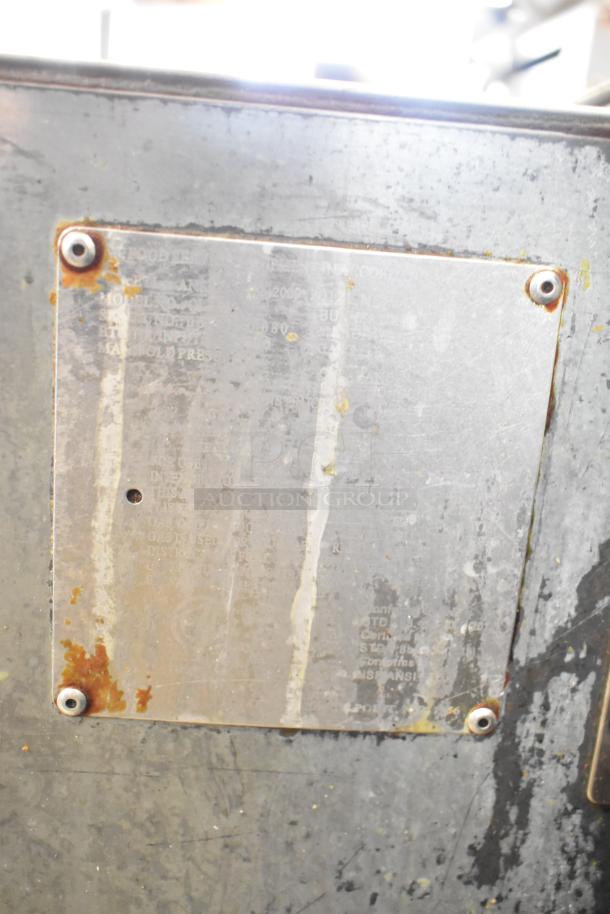 Qualite Commercial Floor Style Gas Deep Fat Fryer, metal surface with visible wear, manufacturer's plate attached.