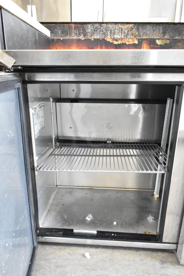 True TUC-72 commercial 3-door undercounter cooler, shown open. Features metal interior, shelf, and caster wheels. 115V, 1 Phase.
