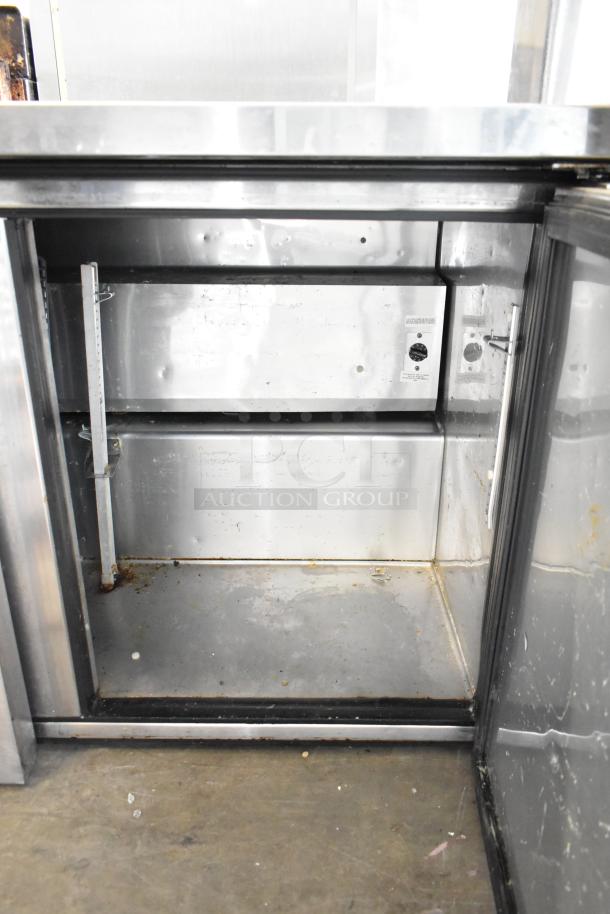 True TUC-72 undercounter cooler, stainless steel interior, three doors, 115V, on commercial casters, used condition.