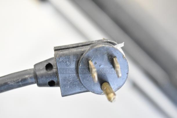 Close-up of a power plug for the True TUC-72 commercial cooler, indicating 115 volts and 1 phase.