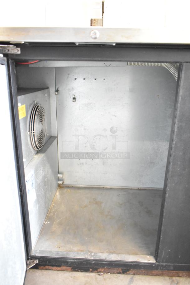 Micro Matic MDD-94 commercial kegerator interior, 115 volts, 1 phase, visible fan, signs of wear, stainless steel.