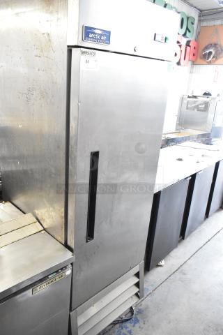 Arctic Air AR23E commercial reach-in cooler, single door, stainless steel, 115 volts, visible wear, model tag present.