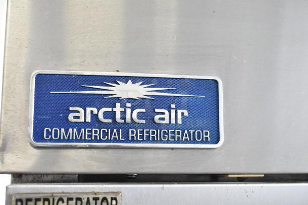 Arctic Air AR23E commercial cooler label, blue with white text, reads "arctic air Commercial Refrigerator."
