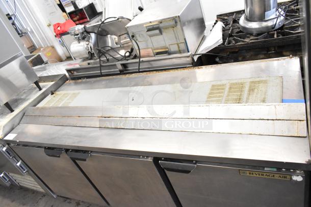 Beverage Air WTR72AY 3-door undercounter cooler with commercial casters, stainless steel, 115 volts, 1 phase, visible wear.