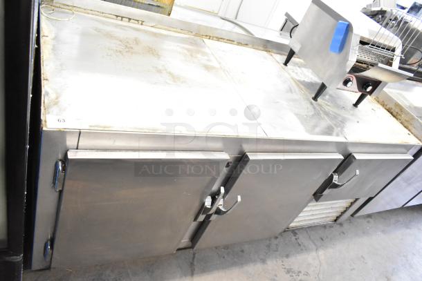 Commercial 3 Door Undercounter Cooler with casters, 115 volts, 1 phase, stainless steel, showing some surface wear.