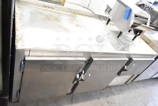 Commercial 3 Door Undercounter Cooler with casters, 115 volts, 1 phase, stainless steel, showing some surface wear.