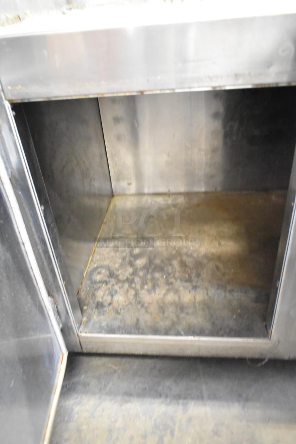 Commercial 3 Door Undercounter Cooler, stainless steel interior, on commercial casters, 115 volts, 1 phase, used condition.