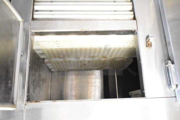 Commercial three-door undercounter cooler on casters, 115 volts, 1 phase. Stainless steel interior, used condition.