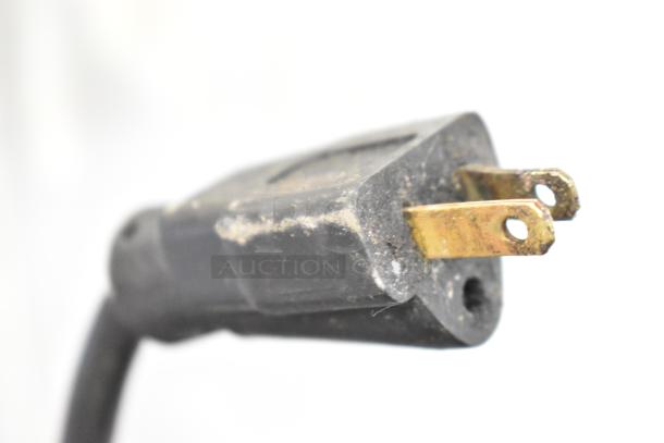 Black power plug for a Commercial 3 Door Undercounter Cooler, showing signs of wear. 115 volts, 1 phase configuration.
