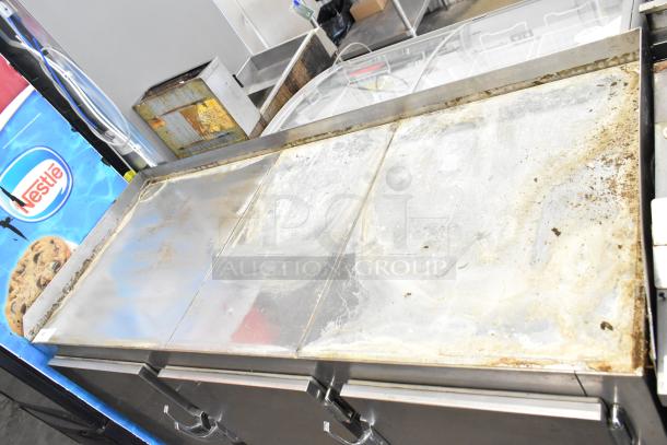 Commercial 3 Door Undercounter Cooler on casters, 115 volts, 1 phase. Stainless steel, visible wear and usage marks.