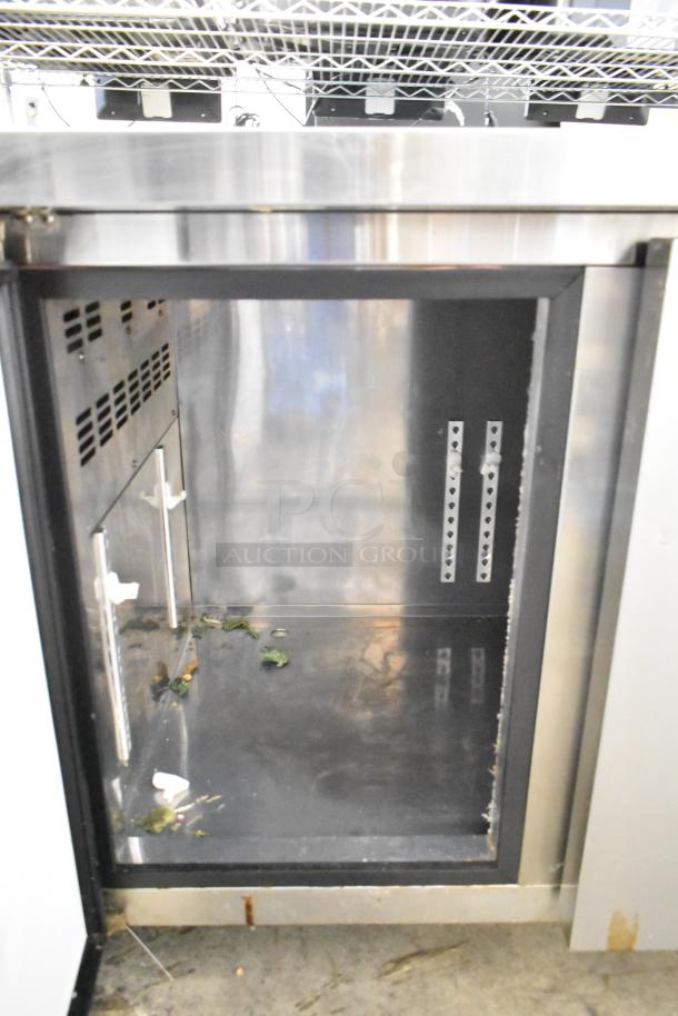 Lassele LT-1833R commercial 3-door undercounter cooler, stainless steel, 115 volts, interior condition shows grime and residue.