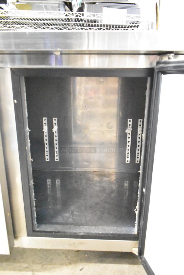 Lassele LT-1833R commercial 3-door undercounter cooler, open door, stainless steel interior, 115 volts, 1 phase.