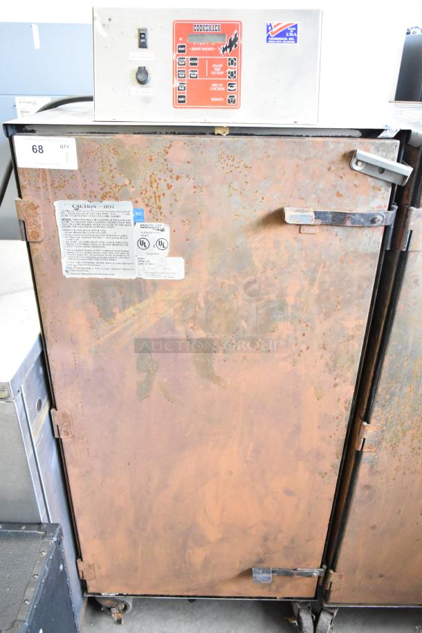 Cookshack 250 Commercial Electric Smoker, 208V, 1 Phase, on casters. Visible wear, labels indicate model and safety warnings.