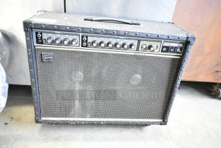 Roland Jazz Chorus 120 amp on casters, features control knobs, iconic design, good condition, ideal for collectors.