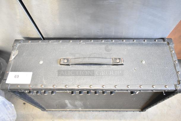 Roland Jazz Chorus 120 speaker, black casing, slight wear, on casters, top handle, visible control knobs, marked as item 69.