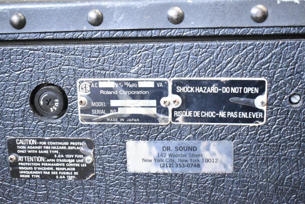 Roland Jazz Chorus 120 Speaker, black textured finish, metal labels indicating model and shock hazard, made in Japan.