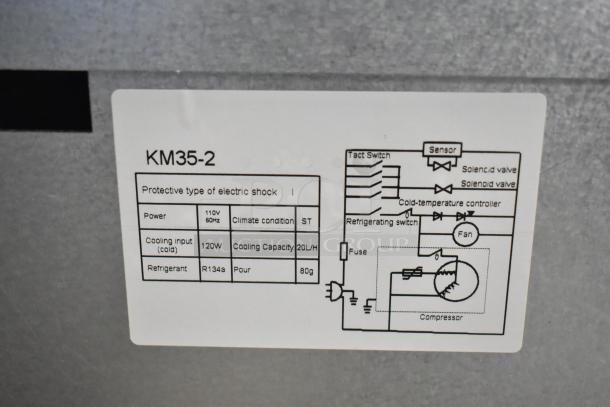 Brand new Elkay KM35-2 wall mount water fountain. Label shows model, power, cooling input, and refrigerant details.