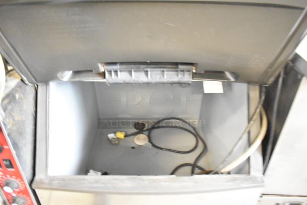 Manitowoc ID0452A-161 ice head on commercial ice bin, 115 volts, 1 phase. Open lid showing interior with some cables.