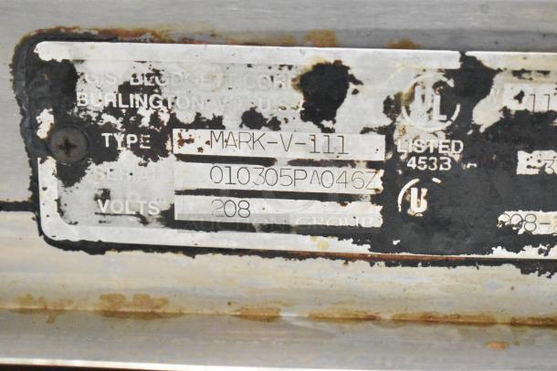 Label of Blodgett Mark-V-111 oven shows model, serial number 010305PA046Z, and volts 208. Worn condition.