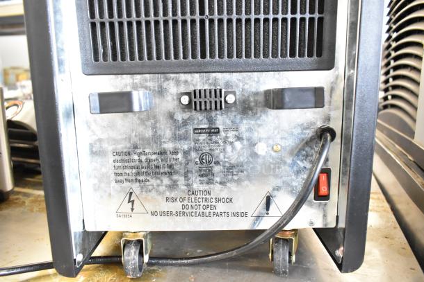 Hercules Heat AGL-05PB portable heater, 120V, 1 Phase. Metal casing, caster wheels, safety warnings on back panel.