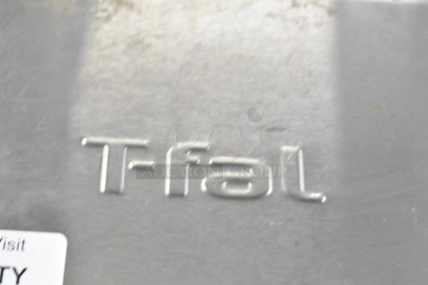 T-Fal OptiGrill Panini Press, stainless steel exterior, 115V, 1 phase, close-up of brand logo.