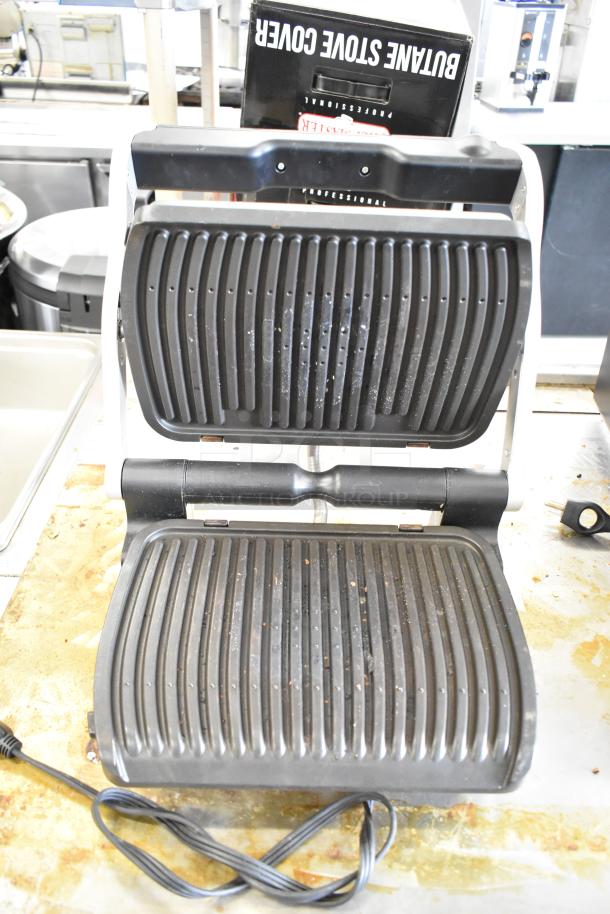T-Fal OptiGrill Panini Press, countertop model, 115 volts, in used condition with visible wear on nonstick grill plates.