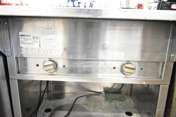 2021 ServIt 423EST2WOPB commercial electric steam table, two-pan open well design, 120V, 1 phase, metal knobs, good condition.