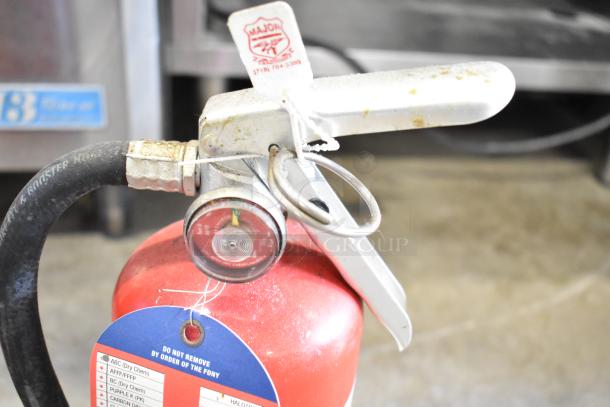 Two fire extinguishers, including a Buckeye model, featuring pressure gauges. Visible tag states, "Do Not Remove by Order of the FDNY." Buyer pickup only.