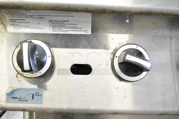 US Range commercial gas charbroiler control panel with two knobs, showing usage instructions. Clean, stainless condition.
