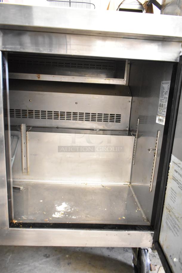 Dukers DSP48 Commercial Sandwich Prep Table, stainless steel, 115V, 1 Phase, on casters, interior view, moderate wear.