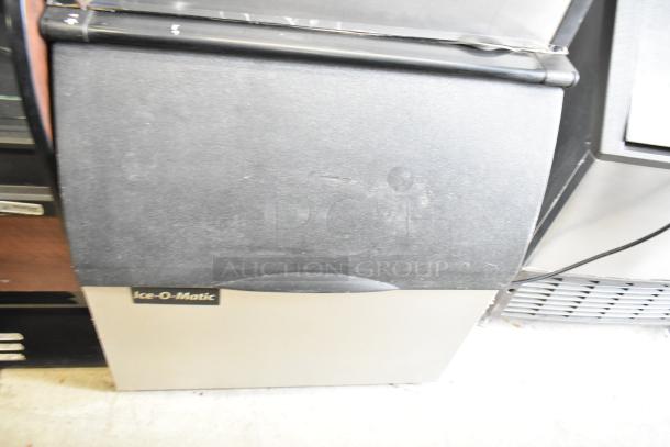 Ice-O-Matic ICE0400FW4 commercial ice head on B40PSB bin. 115 volts, 1 phase. Black and stainless finish, used.