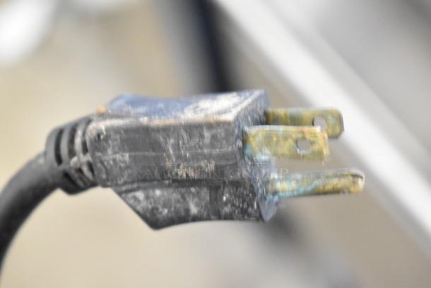 A close-up of a worn power plug, associated with the Cleveland Commercial Floor Style Braising Pan.