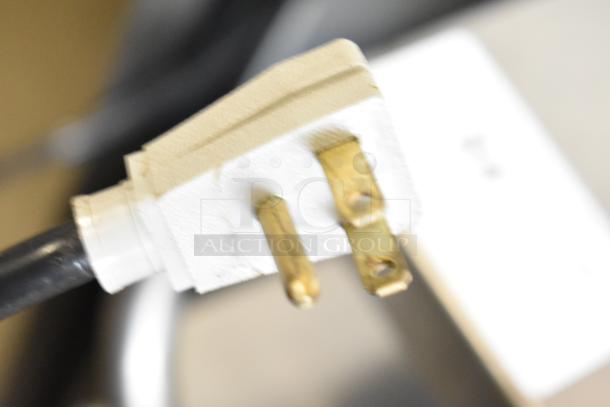 Close-up of 2018 True TG2R-2S-HC cooler's power plug with three prongs, suitable for 115 volts, 1 phase power supply.