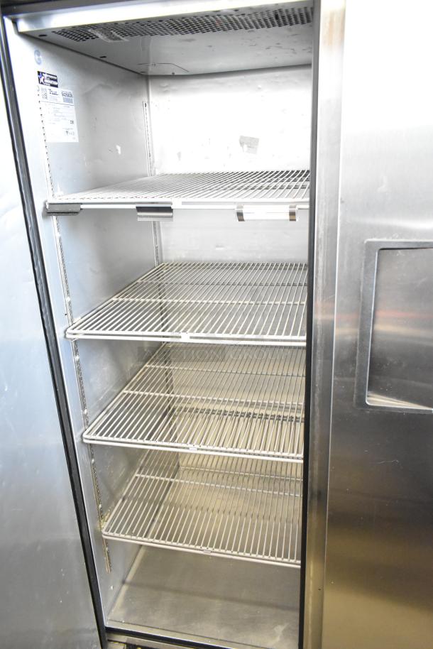 2018 True TG2R-2S-HC commercial reach-in cooler, two-door, shelves visible, model label, 115 volts, good condition.