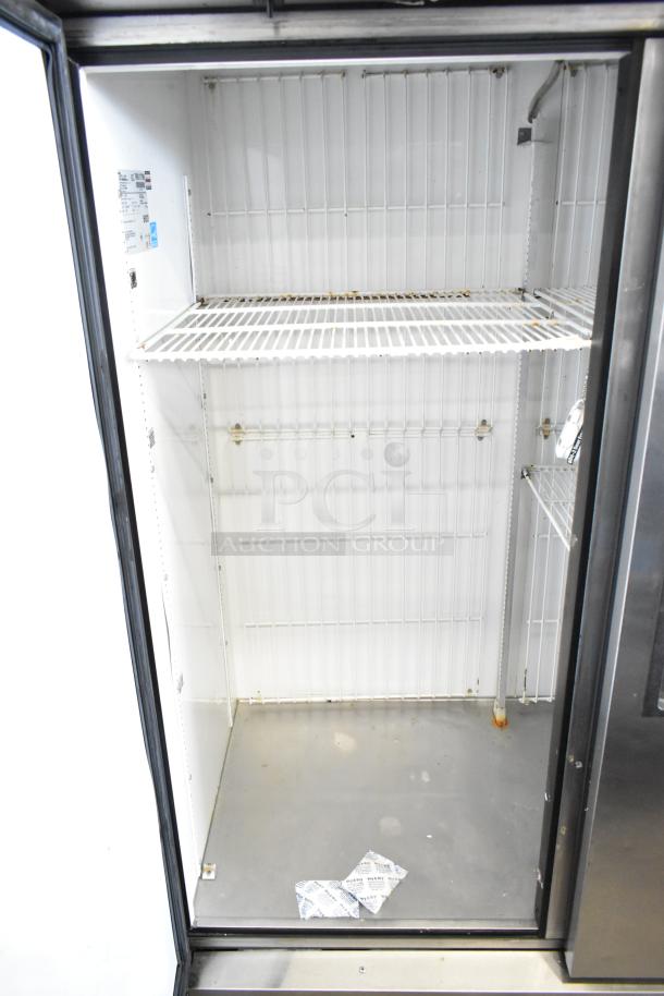 True T-49F Commercial 2 Door Freezer, 115V, 1 Phase, clean interior, visible shelf space, minor wear, ideal for restaurant use.