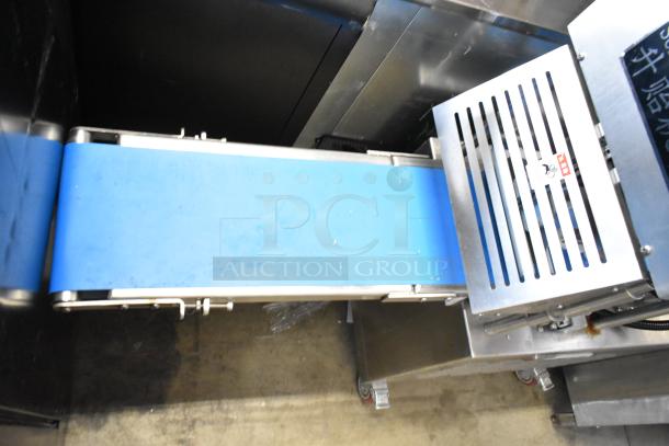 Seny Machinery commercial slicer and conveyor on casters, 220 volts, stainless steel finish, blue belt, excellent condition.