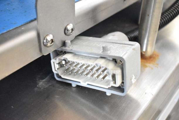 Seny Machinery slicer and conveyor machine connector detail. Shows plug design and metal attachments; operates on 220 volts.